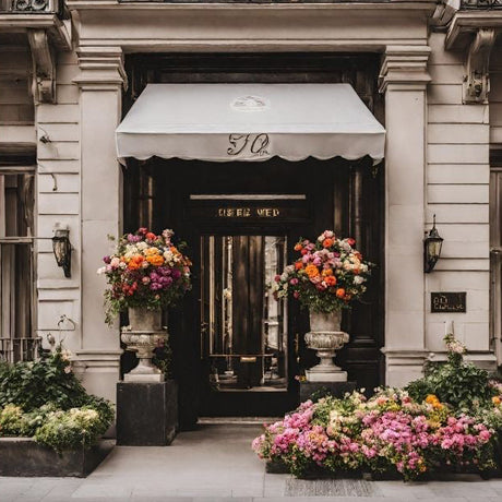 Fancy hotel frontage with beautiful flowers in urns and containers either side of the doorway