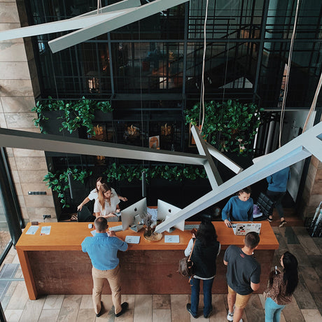 Looking down at at a hotel reception desk from a high ceiling