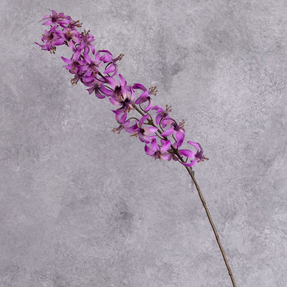 A single faux lily stem, with an abundance of pinkish purple flowers all the way up the top part of the stem