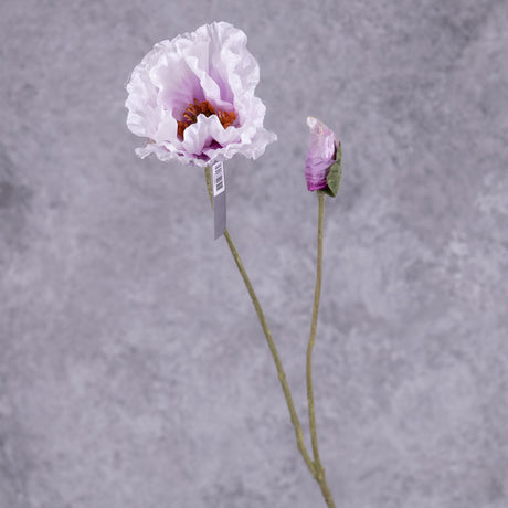 A faux poppy stem with an open flower and a budding flower on two branchlets. The flowers are a pale lavender colour that gets darker toward the centre of the flower