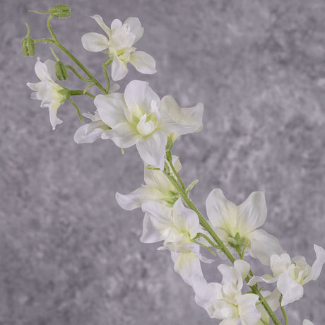 A close up of a faux delphinium with white flowers